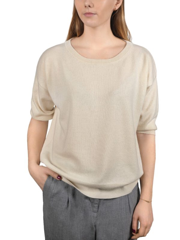 Kaszmirowy sweter z krótkim rękawem w kolorze kremowym na modelce od przodu