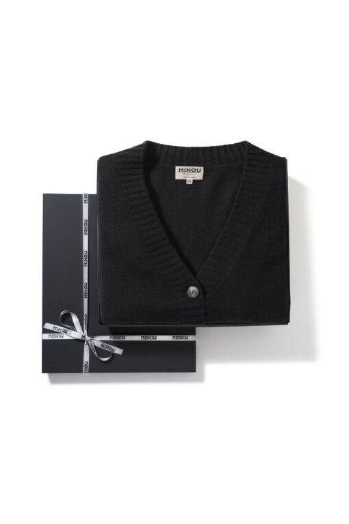 black cardigan folded in a gift box