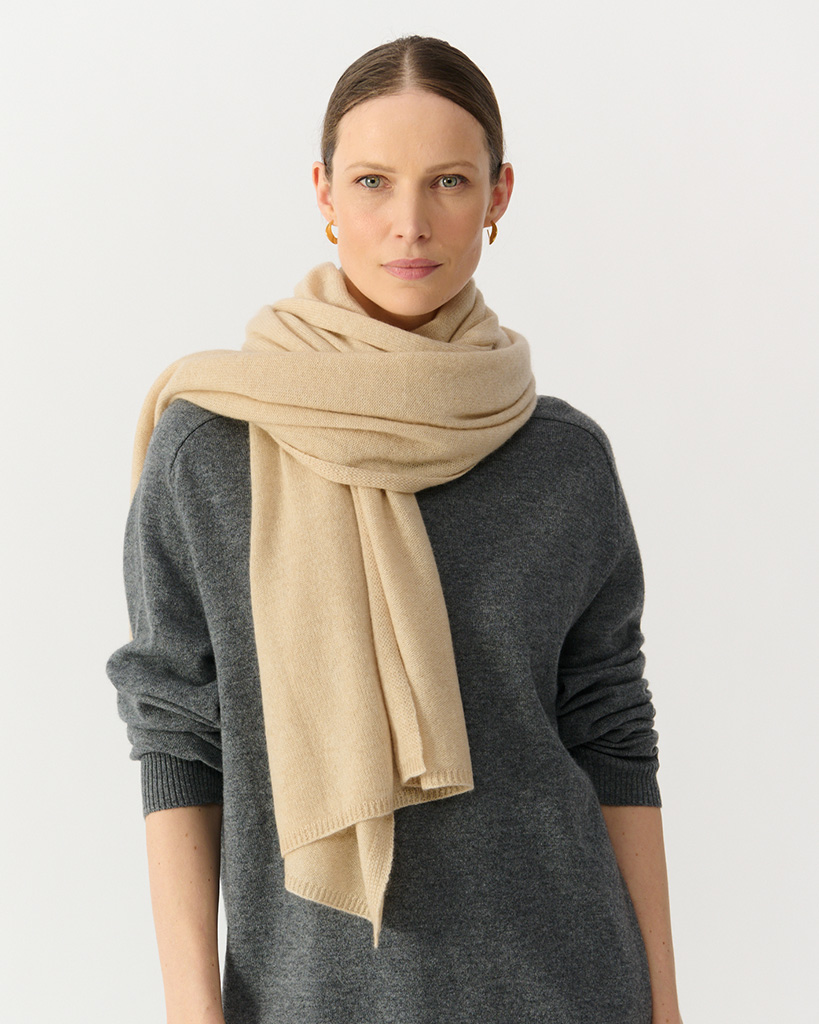 model in beige knitted scarf